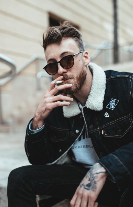 Steve smokes a cigarette.